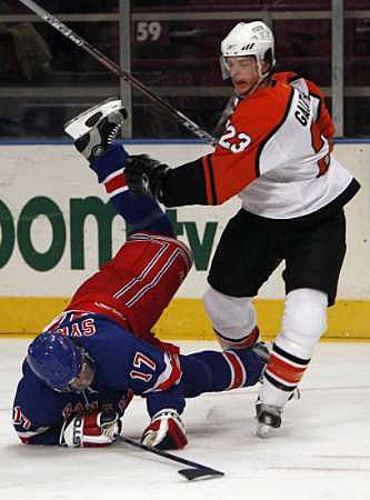 Obránce Denis Gauthier z Philadelphie (vpravo) poslal k zemi útočníka NY Rangers Petra Sýkoru. | Foto: Reuters