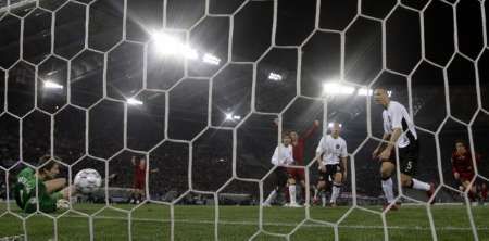 Fotbalista AS Řím Rodrigo Taddei (vpravo, vzadu) skóruje podél gólmana Manchesteru United Edwina van der Sara (vlevo). | Foto: Reuters