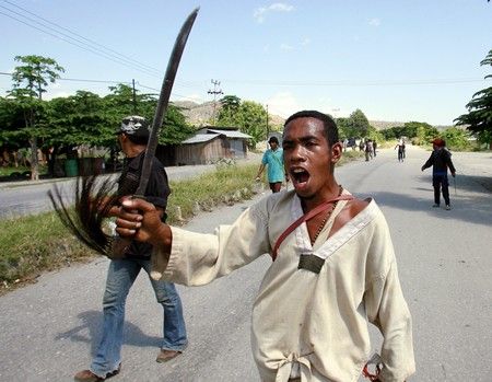 Boje ve Východním Timoru mezi vládou a stovkami propuštěných vojáků a jejich příznivců pokračují. Členové rebelů mají primitivní zbraně - mačety, nože, bumerangy nebo praky... | Foto: REUTERS/Adrees Latif