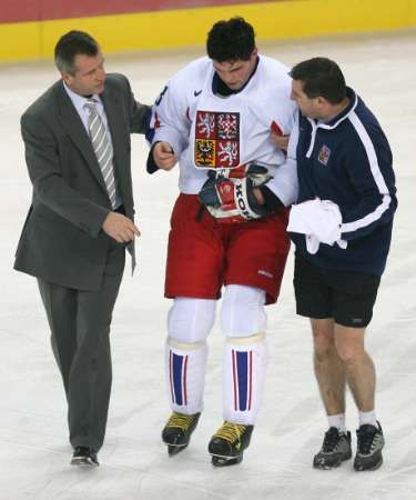 Zraněný Jaromír Jágr míří s pomocí lékaře a maséra pryč z ledu na olympiádě v Turíně 2006. | Foto: Reuters