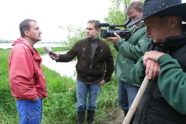 Kdo sleduje televizi, tomu není třeba tento štáb představovat. Právě zpovídá obyvatele Kvasic, kteří pomáhali u nového jezera vršit provizorní hráz z písku. | Foto: Karel Toman