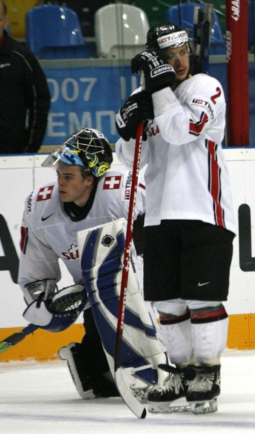 Švýcarský brankář Jonas Hiller a jeho spoluhráč Beat Gerber vstřebávají vyřazení od Kanady ve čtvrtfinále světového šampionátu v Moskvě. | Foto: Reuters