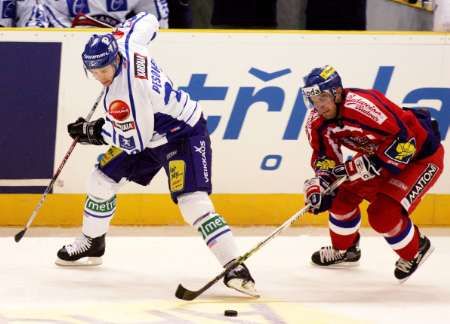 Český hokejista Petr Hubáček v souboji o puk s Jussi Pesonenem během utkání Euro Hockey Tour v Libereci | Foto: Reuters