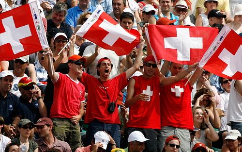 Fanoušci Rodera Federera mávají švýcarskými vlajkami ve finále Roland Garros. | Foto: Reuters