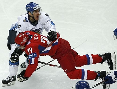 Rus Alexander Frolov (v červeném) naráží do Pekky Sarava z Finska. | Foto: Reuters