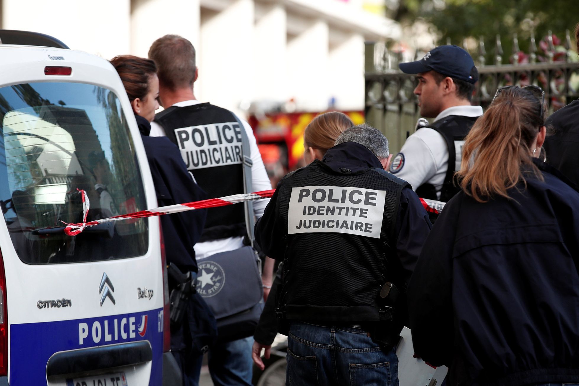 French police have detained four people for the murder of a teacher in the suburbs of Paris