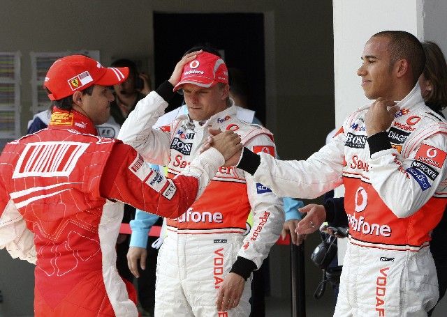 Felipe Massa ze stáje Ferrari (vlevo) si potřásá rukou s Lewisem Hamiltonem po kvalifikaci na VC Turecka, vzadu přihlíži druhý pilot McLarenu Heikki Kovalainen. | Foto: Reuters