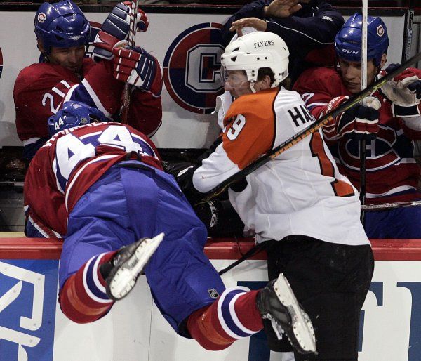 Scott Hartnell z týmu Philadelphia Flyers posílá na střídačku Romana Hamrlika (44) z Montrealu Canadiens. | Foto: Reuters