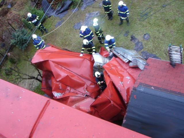 Hasiči v Polici nad Metují likvidují část utržené plechové střechy. | Foto: HZS Královehradeckého kraje