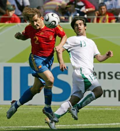 Španěl Michel Salgado (vlevo) bojuje o míč s Husseinem Sulaimanim ze Saúdské Arábie. | Foto: Reuters