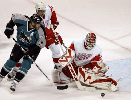 Dominik Hašek při zákroku proti Joe Thorntonovi ve třetím utkání čtvrtfinále play off. | Foto: Reuters