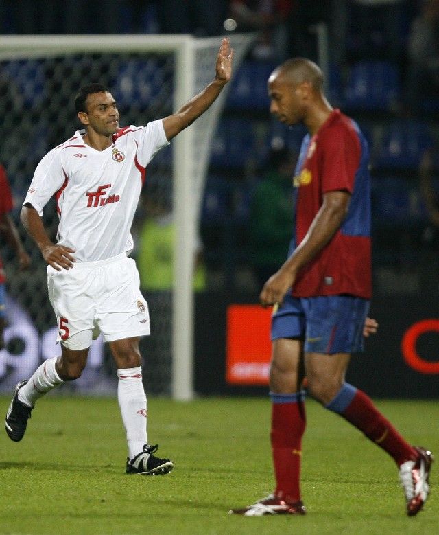 Guedes de Lima Cleber z Wisly Krakov se raduje z gólu do sítě Barcelony, zatímco Thierry Henry kráčí do středového kruhu. | Foto: Reuters