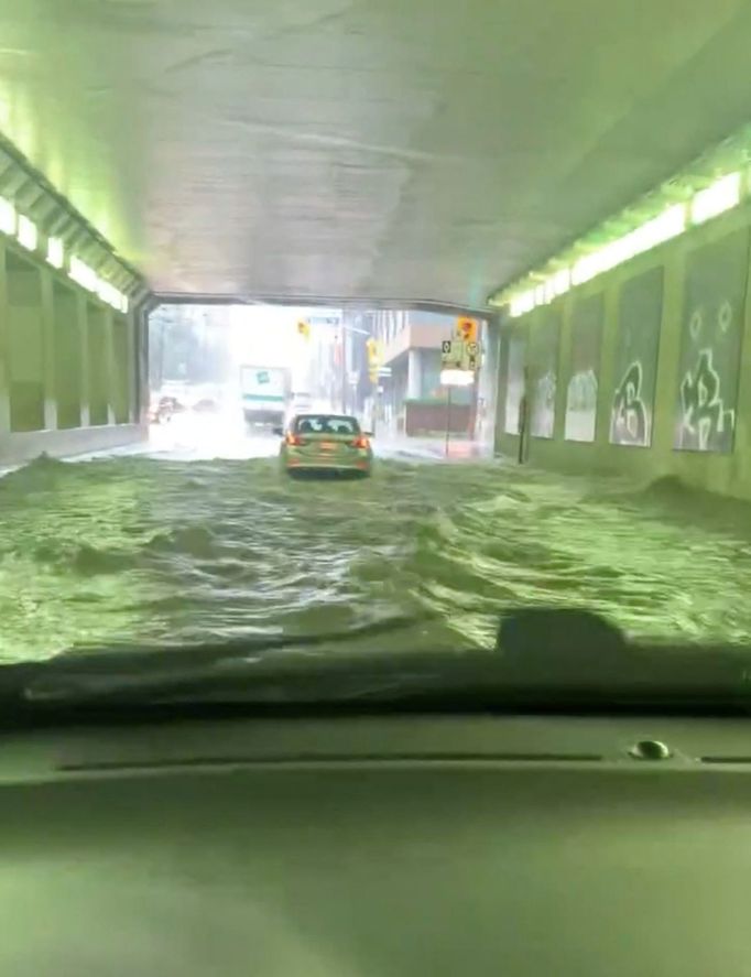 A car passes through a flooded tunnel following torrential rains, in Toronto, Canada, July 16, 2024, in this screen grab taken from a social media video. BRYAN MASON/via