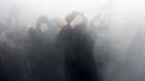 Russian nationalists cover their faces as they walk in a smog during a "Russian March" demonstration on National Unity Day in Moscow November 4, 2012. Russia marks the National Unity Day on November 4 when it celebrates the defeat of Polish invaders in 1612. REUTERS/Mikhail Voskresenskiy (RUSSIA - Tags: POLITICS CIVIL UNREST TPX IMAGES OF THE DAY) Published: Lis. 4, 2012, 2:25 odp.