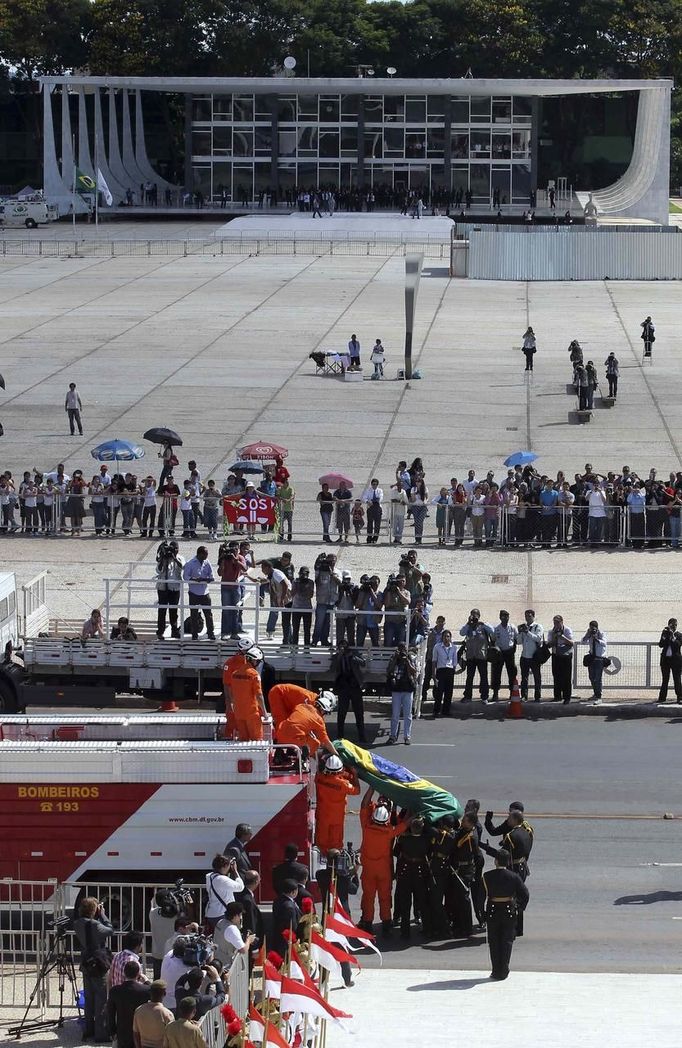 Guards unload the coffin of Oscar Niemeyer from a fire engine upon arrival at Planalto Palace in Brasilia December 6, 2012. Niemeyer, a towering patriarch of modern architecture who shaped the look of modern Brazil and whose inventive, curved designs left their mark on cities worldwide, died late on Wednesday. He was 104. Niemeyer had been battling kidney and stomach ailments in a Rio de Janeiro hospital since early November. His death was the result of a lung infection developed this week, the hospital said, little more than a week before he would have turned 105. REUTERS/Paulo Whitaker (BRAZIL - Tags: SOCIETY OBITUARY) Published: Pro. 6, 2012, 7:41 odp.