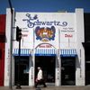 Man walks past the kosher Schwartz Bakery in the Fairfax district of Los Angeles, California