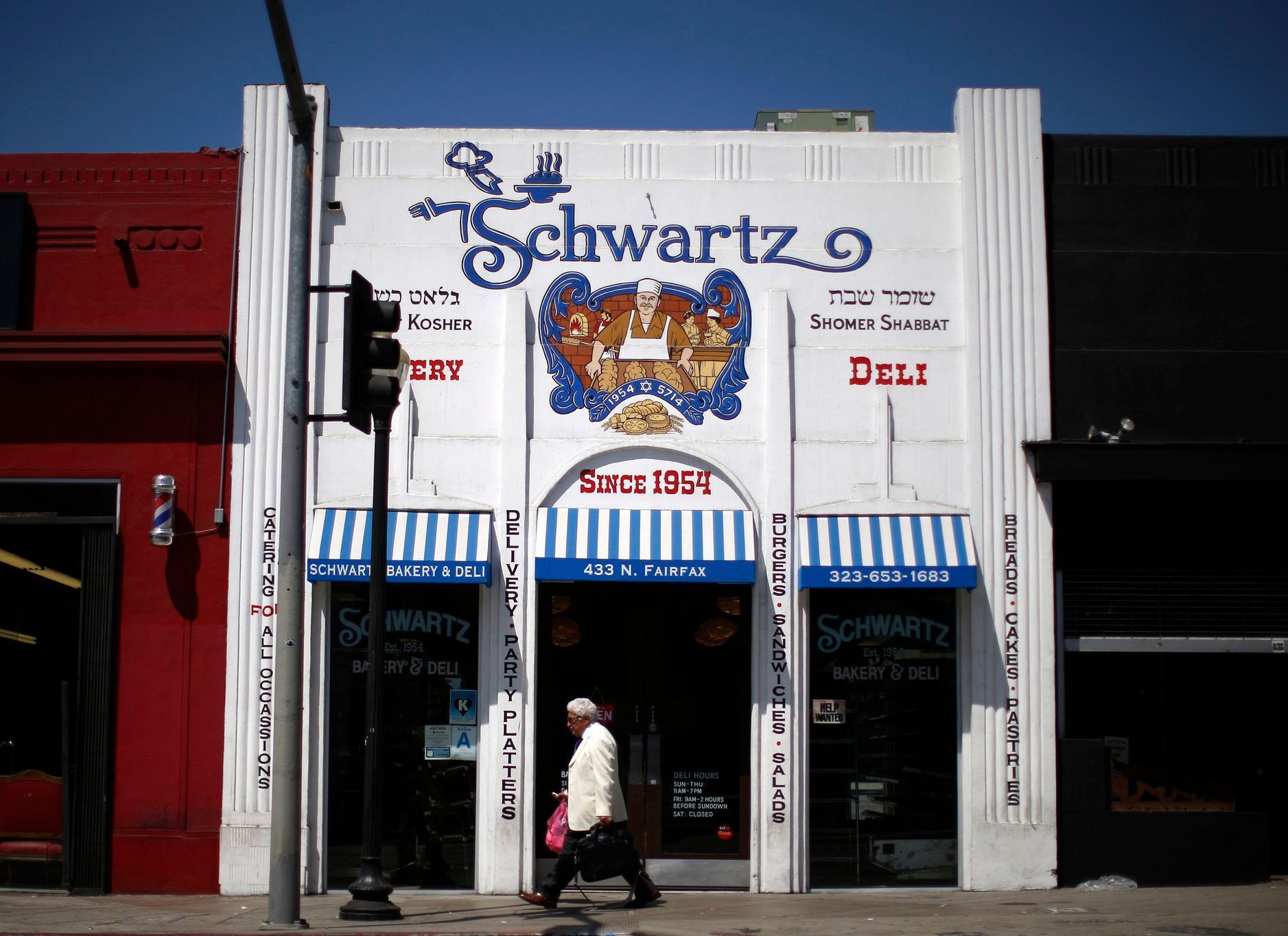 Man walks past the kosher Schwartz Bakery in the Fairfax district of Los Angeles, California
