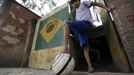 Gabriel Muniz, 11, poses with a soccer ball outside his house in Campos dos Goytacazes, 274 kilometres (170 miles) northeast of Rio de Janeiro August 23, 2012. Despite being born with malformation of his feet, fourth grader Gabriel puts in hours into soccer everyday in his neighbourhood. He aspires to be a professional soccer player just like his idol Argentina's Lionel Messi of Barcelona FC. REUTERS/Ricardo Moraes (BRAZIL - Tags: SPORT SOCCER SOCIETY TPX IMAGES OF THE DAY HEALTH) Published: Srp. 24, 2012, 2:25 dop.