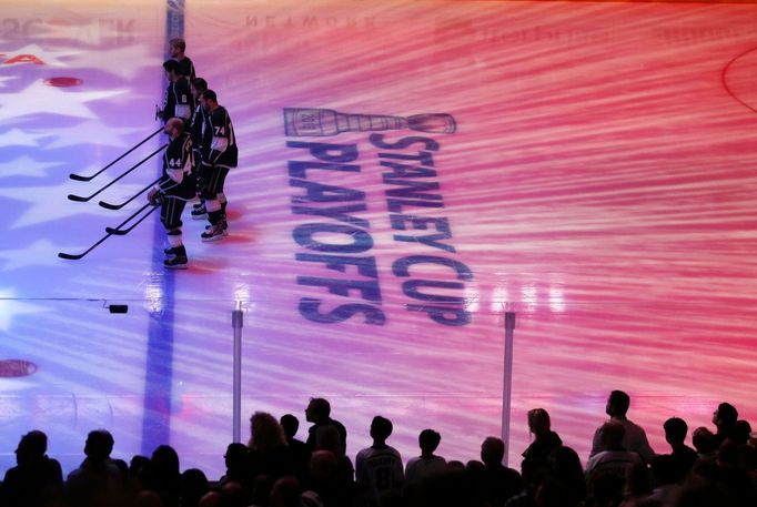 Los Angeles Kings players stand during the playing of the national anthem, before the start of Game 1 of their NHL Western Conference semifinal playoff hockey game agains