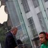 A man waits outside the Apple Store in advance of an Apple special event, in the Manhattan borough of New York