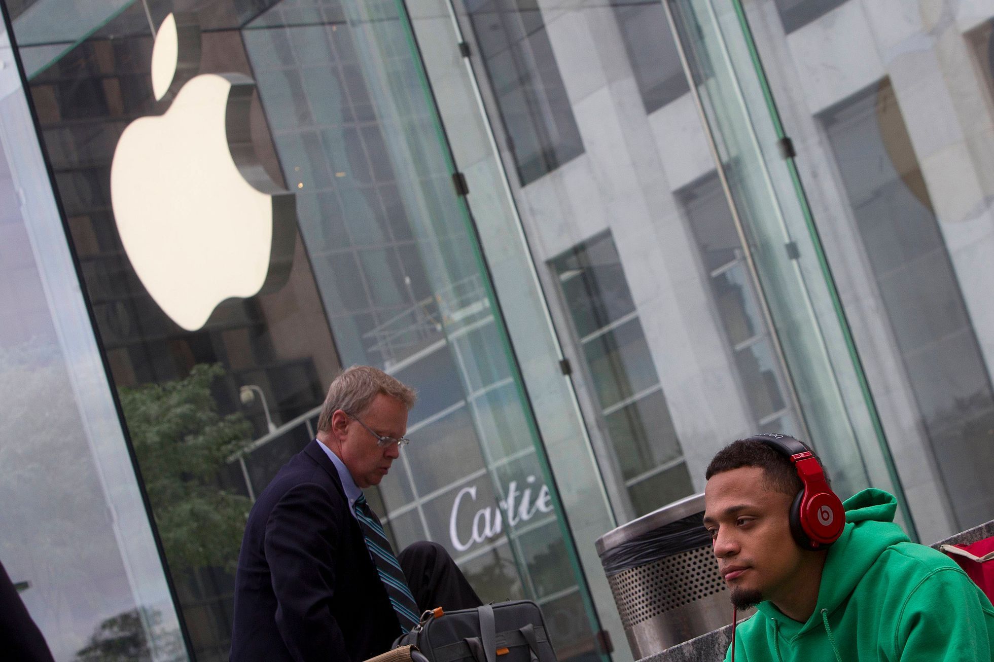 A man waits outside the Apple Store in advance of an Apple special event, in the Manhattan borough of New York