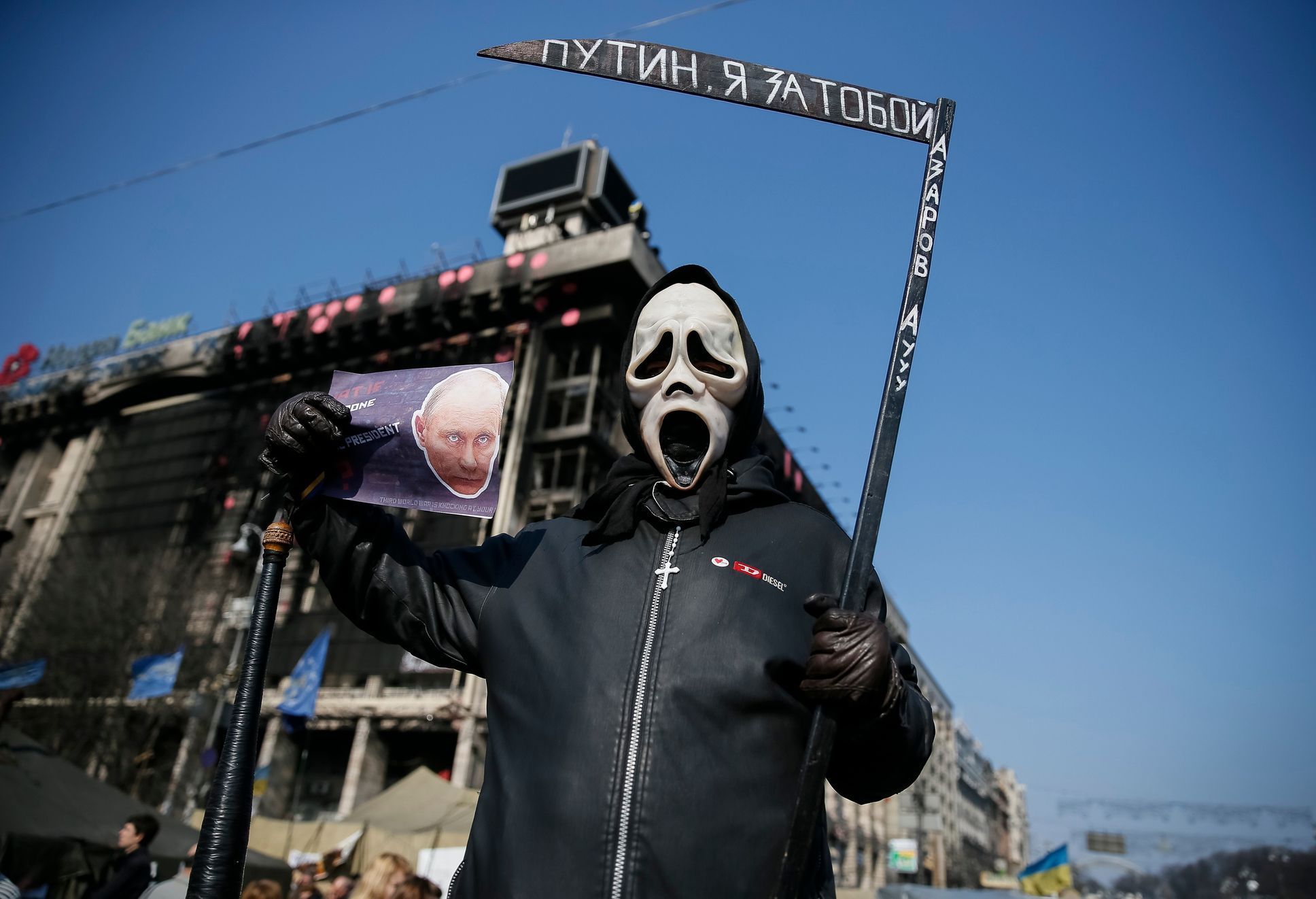 Participant hold a sign depicting Russian President Vladimir Putin as he attends an anti-war rally at Independence Square in Kiev
