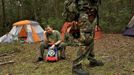 A young boy sits on a child's toy and sulks because his sister got to carry the rifle that he wanted to carry as members of the North Florida Survival Group gather for a field training exercise in Old Town, Florida, December 8, 2012.The group trains children and adults alike to handle weapons and survive in the wild. The group passionately supports the right of U.S. citizens to bear arms and its website states that it aims to teach "patriots to survive in order to protect and defend our Constitution against all enemy threats". Picture taken December 8, 2013. REUTERS/Brian Blanco (UNITED STATES - Tags: SOCIETY POLITICS) ATTENTION EDITORS: PICTURE 18 OF 20 FOR PACKAGE 'TRAINING CHILD SURVIVALISTS' SEARCH 'FLORIDA SURVIVAL' FOR ALL IMAGES Published: Úno. 22, 2013, 1:01 odp.