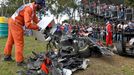 track marshall empties a box of debris collected from a car after a crash during the Australian Formula One Grand Prix in Melbourne.