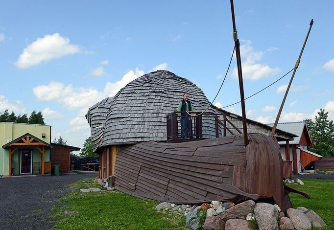 TO GO WITH AFP STORY by ANNA MARIA JAKUBEK - Grzegorz Skalmowski, owner of the "Snail Garden", stands at the balcony of his company office in shape of a snail at his farm in Krasin, northern Poland, on May 29, 2013.