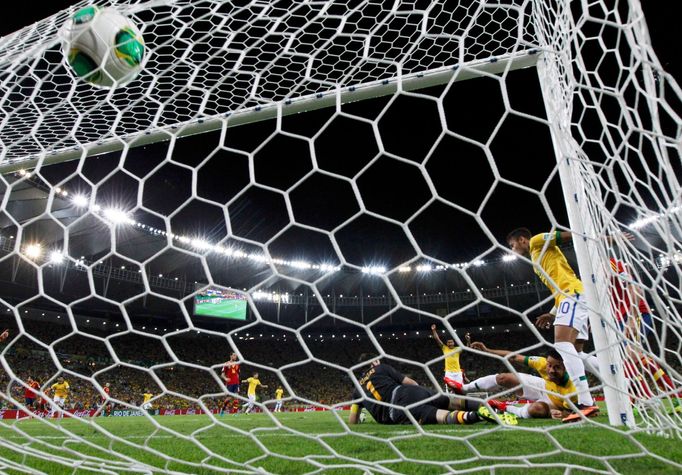 Brazil's Fred (2nd R) scores a goal against Spain's goalkeeper Iker Casillas during their Confederations Cup final soccer match at the Estadio Maracana in Rio de Janeiro