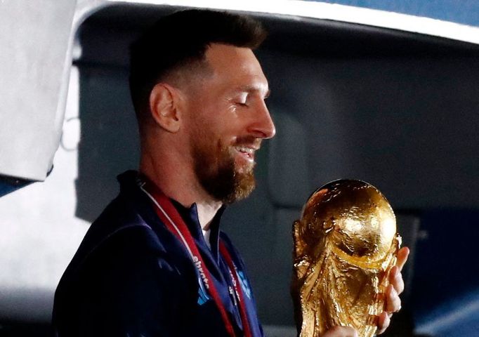 Soccer Football - Argentina team arrives to Buenos Aires after winning the World Cup  - Buenos Aires, Argentina - December 20, 2022 Argentina's Lionel Messi with the trop