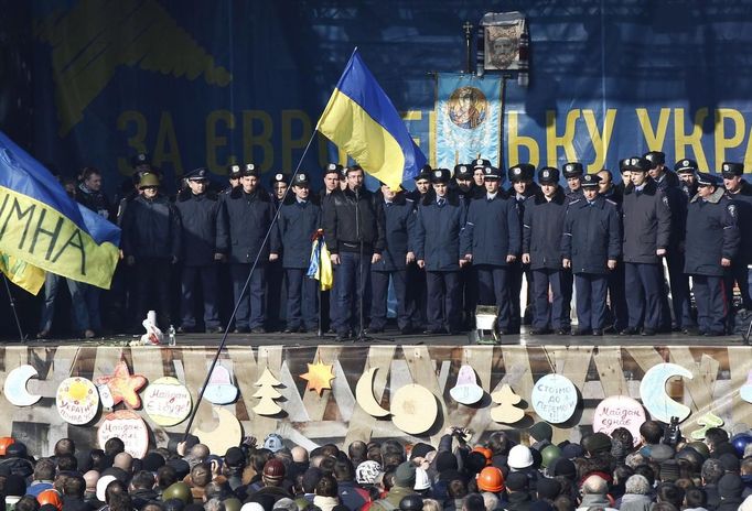 Police officers from Lviv who have arrived to join anti-government protesters appear on a stage in Independence Square in Kiev February 21, 2014.