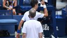 Sep 6, 2020; Flushing Meadows, New York, USA; Novak Djokovic of Serbia discusses with a tournament official after being defaulted for striking a lines person with a ball