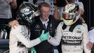 Second placed Mercedes Formula One driver Nico Rosberg of Germany (L) shakes hands with race winner and team mate Lewis Hamilton of Britain in the Parc Ferme after the Au