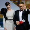 Director Andrey Zvyagintsev, Best screenplay award winner for his film &quot;Leviathan&quot;, celebrates on stage next to Spanish actress Paz Vega during the closing ceremony of the 67th Cannes Film F