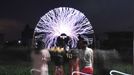 Performing With Lightning CHANGLE, CHINA - AUGUST 12: (CHINA OUT) A guitarist plays guitar as high voltage of up to 1 million volts, generated by a Tesla coil transformer, runs through his body during a stunt performance on August 12, 2012 in Changle, Fujian Province of China. Wang Zengxiang, one of the craziest fans of the Tesla coil stunt, has dedicated himself in the daredevil career for a decade. He is now the leader of a band of four. A Tesla coil is an electrical resonant transformer circuit invented by Nikola Tesla around 1891. The transformer produces high voltage at high frequencies, which acts as a giant lightning machine, and creates long bolts of electricity. Shielded by protective clothing, the performer is insulated from the electricity current which dissipates through the ground.