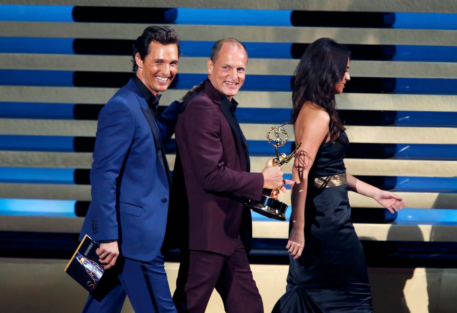 Presenters McConaughey and Harrelson walk offstage with the award for Outstanding Lead Actor In A Miniseries Or A Movie for Benedict Cumberbatch for his role in &quot;Sherlock: His Last Vow&quot; onst