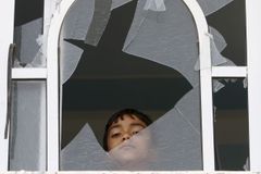 A Palestinian child looks out of a broken window of his family house damaged following an Israeli airstrike in east Gaza City, Friday, April 8, 2011. Israeli aircraft and ground forces struck Gaza on Friday in a surge of deadly fighting sparked by a Palestinian rocket attack on an Israeli school bus the day before. Just over two years after rocket fire from Gaza drew a devastating Israeli incursion in the territory, Israel and Gaza's Hamas rulers seemed poised on the brink of another round of intense violence. (AP Photo/Adel Hana) =@=