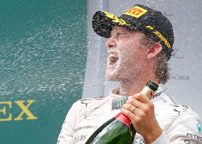 Winning Mercedes Formula One driver Nico Rosberg of Germany is showered with champagne by his team mate and 2nd placed Lewis Hamilton of Britain (not pictured) during the