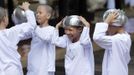 Novice Thai nuns smile at the Sathira Dammasathan Buddhist meditation centre in Bangkok