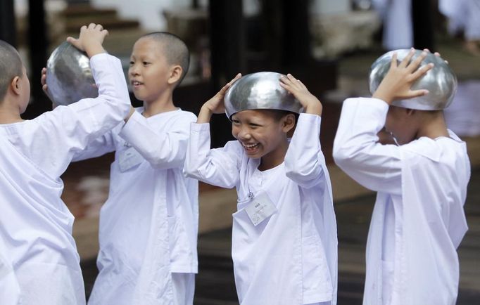 Novice Thai nuns smile at the Sathira Dammasathan Buddhist meditation centre in Bangkok