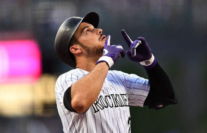 Jun 28, 2019; Denver, CO, USA; Colorado Rockies third baseman Nolan Arenado (28) celebrates after hitting a two run home run against the Los Angeles Dodgers in the first