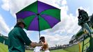 Kei Nishikori of Japan changes his shirt during his men's singles tennis match against Matthew Ebden of Australia at the Wimbledon Tennis Championships, in London June 25