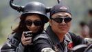 A couple rides a Harley Davidson motorcycle during the annual Harley Davidson National Rally in Qian Dao Lake, in Zhejiang Province May 11, 2013. Around 1,000 Harley Davidson enthusiasts from all over China met to celebrate the 5th Harley Davidson National Rally in China, as part of the company's 110-year anniversary. Major Chinese cities ban motorcycles from circulating on highways and major avenues. Meanwhile, Harley Davidson motorbikes are considered by Chinese tax authorities to be luxury items, so they are taxed at extremely high rates-- sometimes the taxes alone is equivalent to the bike's U.S. price tag. Traffic and transportation authorities have also weighed in, putting Harleys in the same category as electric bikes, horses and bicycles, meaning that they cannot be on highways and major avenues. Picture taken May 11, 2013. REUTERS/Carlos Barria (CHINA - Tags: TRANSPORT SOCIETY) Published: Kvě. 13, 2013, 11:05 odp.