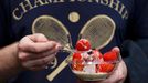 A spectator eats strawberries and cream at the Wimbledon Tennis Championships, in London June 26, 2013. REUTERS/Suzanne Plunkett (BRITAIN - Tags: SPORT TENNIS)