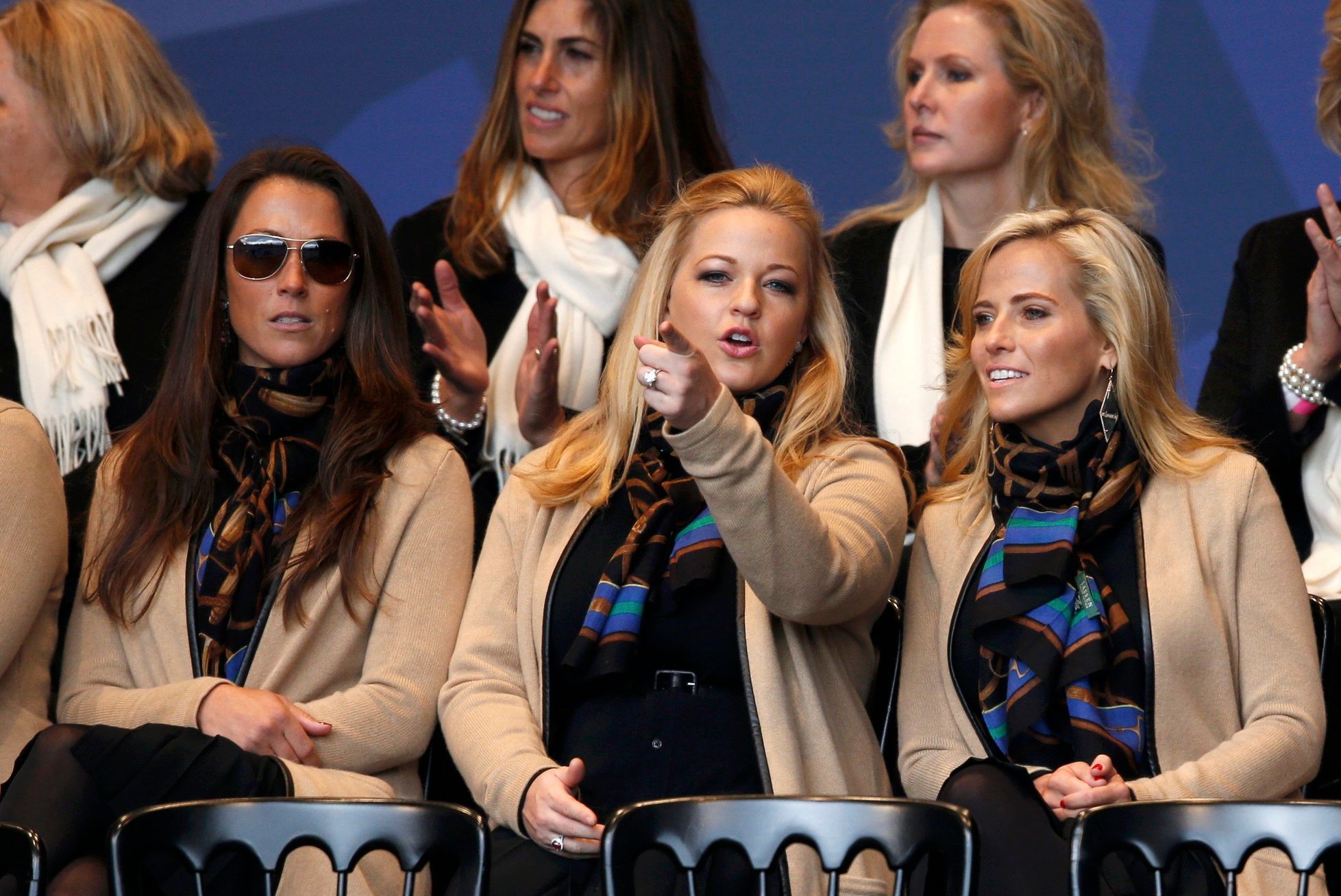 Wives and partners Sybi Kuchar, Kandi Mahan and Amy Mickelson of U.S. Team players, sit together for the opening ceremony of the 40th Ryder Cup at Gleneagles