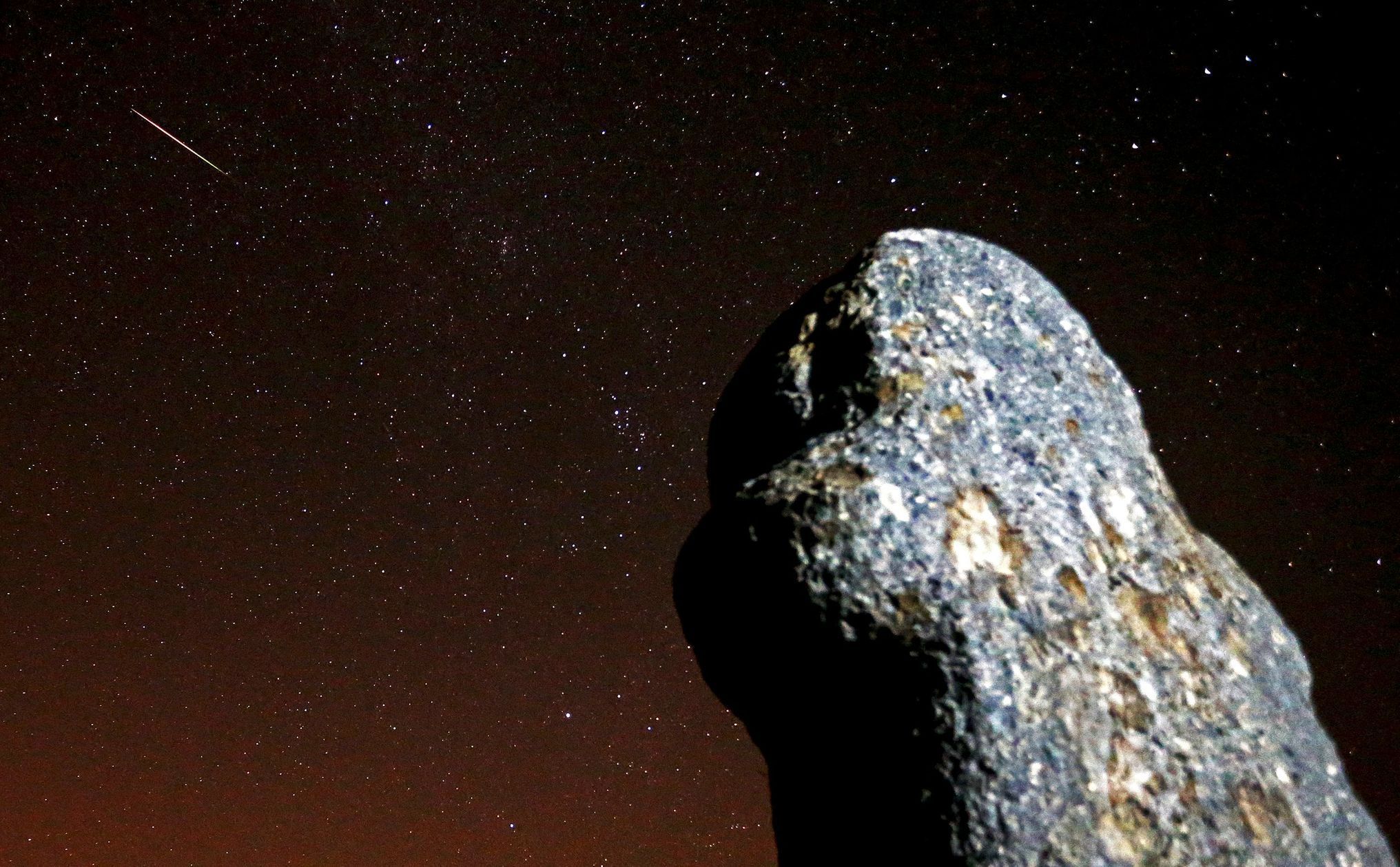 A meteor streaks across the sky during the Perseid meteor shower at the Maculje archaeological site near Novi Travnik in the early morning