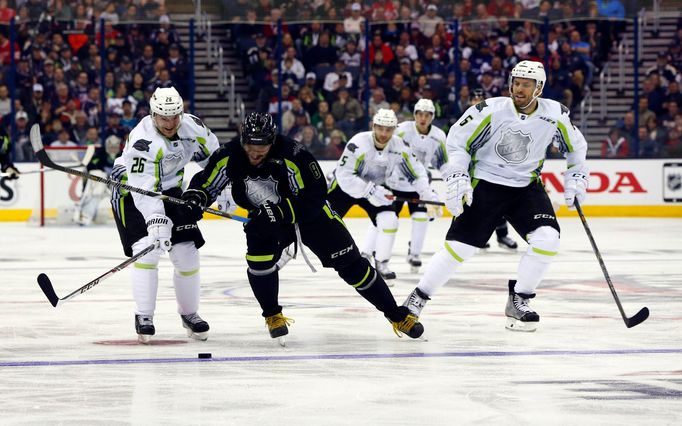 Jan 25, 2015; Columbus, OH, USA; Team Foligno forward Alex Ovechkin (8) of the Washington Capitals battles for the puck with Team Toews center Patrik Elias (26) of the Ne