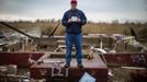 Pastor Joseph Paul Morrissey holds his pocket Bible as he poses for a photograph amidst the ruins of his home in the low-lying Oakwood neighbourhood on Staten Island November 14, 2012. Morrissey, a general contractor and owner of a small productions company, worked with his fellow parishioners to transform the Grace Bible Church, just steps away, into a relief and aid center for victims of the storm. Despite losing everything, Morrissey and other members the small Christian congregation have worked tirelessly to keep their church open as an aid center. Picture taken November 14, 2012. REUTERS/Mike Segar (UNITED STATES - Tags: DISASTER ENVIRONMENT RELIGION TPX IMAGES OF THE DAY) ATTENTION EDITORS PICTURE 06 19 FOR PACKAGE 'SURVIVING SANDY' SEARCH 'SEGAR SANDY' FOR ALL PICTURES Published: Lis. 20, 2012, 3:30 odp.