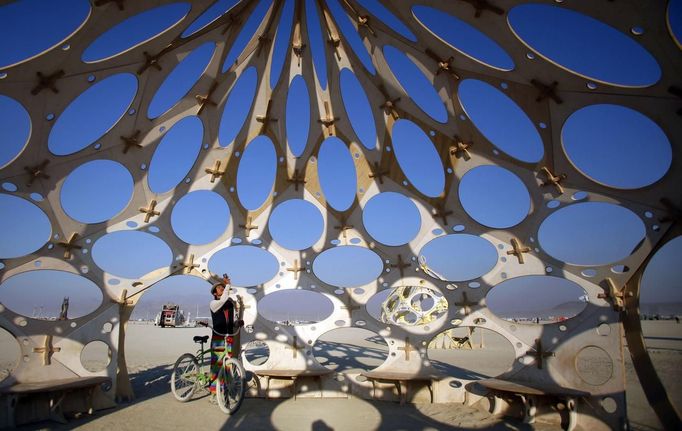 Bingram Lai explores "Zonotopia and the Two Trees" during the Burning Man 2012 "Fertility 2.0" arts and music festival in the Black Rock Desert of Nevada, August 29, 2012. More than 60,000 people from all over the world have gathered at the sold out festival, which is celebrating its 26th year, to spend a week in the remote desert cut off from much of the outside world to experience art, music and the unique community that develops.